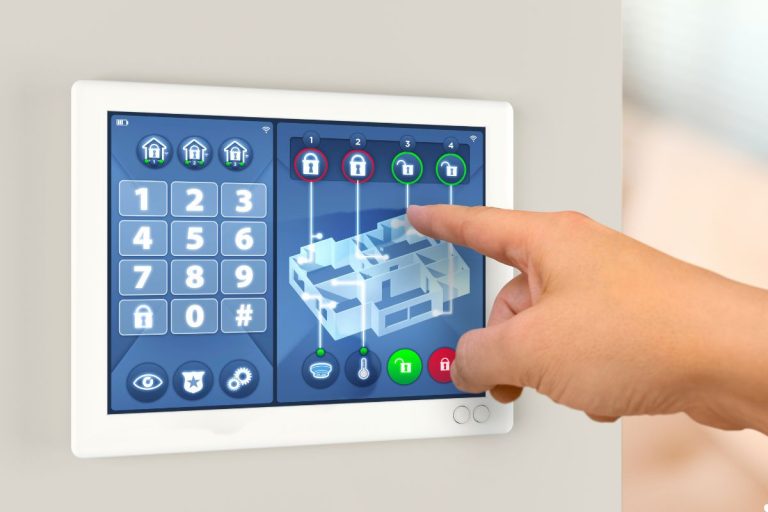 A person interacting with a wall-mounted touch screen, their hand reaching out to touch the display.