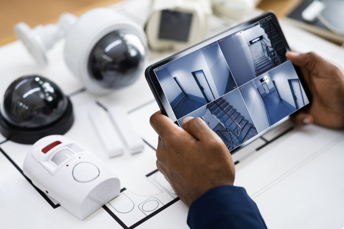 A person viewing security camera feeds on a tablet, ensuring safety and monitoring surroundings effectively.