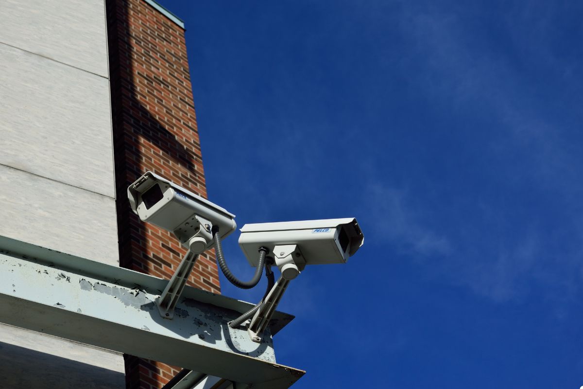 Two security cameras installed on the exterior wall of a building, monitoring the surrounding area for safety.